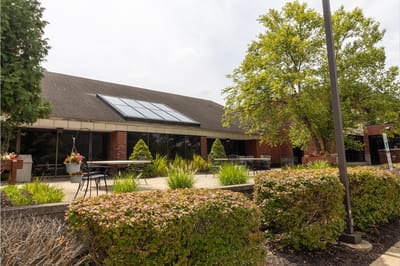 Outdoor seating area with greenery at the facility
