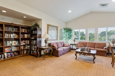 Comfortable common area with bookshelves and seating
