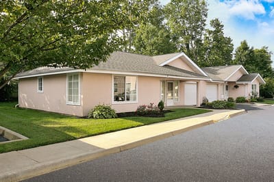 Exterior view of a senior living facility with landscaped gardens
