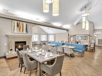Dining area with tables set and a fireplace