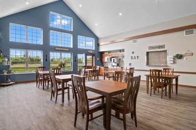 Bright dining area with wooden tables and large windows