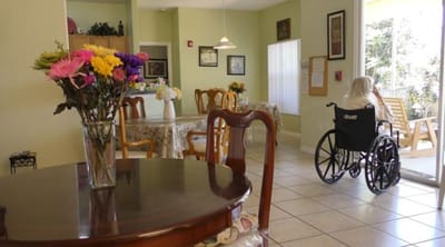 A resident in a wheelchair in a bright common area
