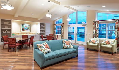 Bright common area with sofas and dining tables