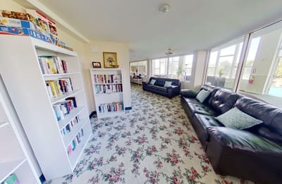 Bright common area with seating and bookshelves