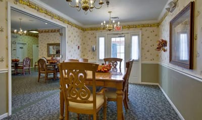 A dining room in a senior living facility with a table set
