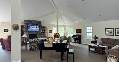 Bright common area with a piano and seating