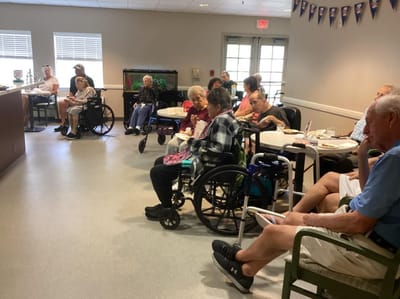 Residents seated in a common area during an activity