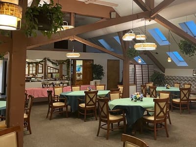 Dining area with green tables and chairs
