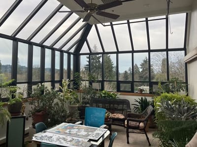 Bright sunroom filled with plants and seating