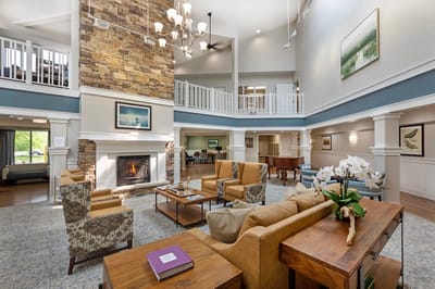 Common area with seating and a fireplace in a senior living facility