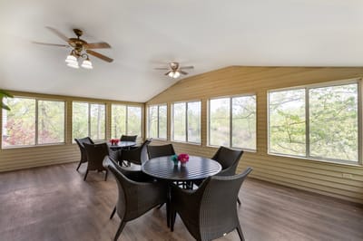 Bright sunroom with seating and large windows