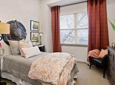 Cozy private bedroom with floral bedding and warm decor
