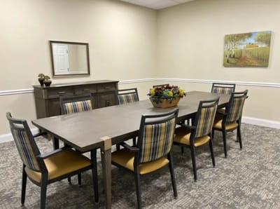 Interior of a dining room with a large table and chairs