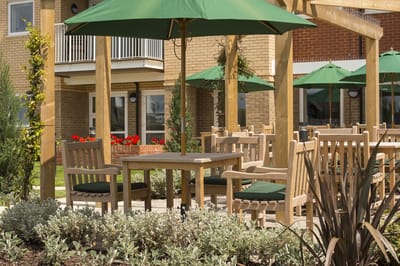 Outdoor seating area with umbrellas and greenery