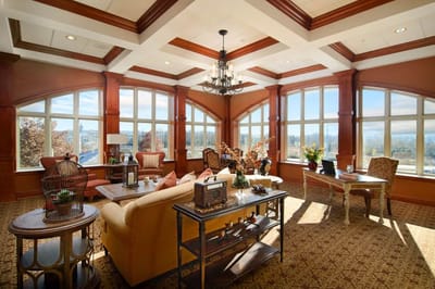 Bright common area with large windows and cozy seating