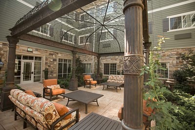 Outdoor patio area with seating and greenery