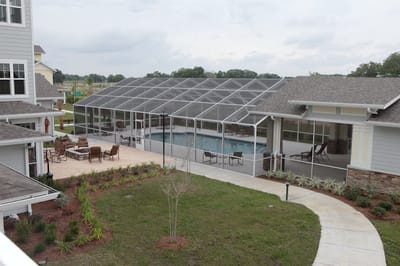 Outdoor pool area with seating and landscaping