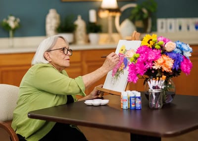 Resident painting flowers during an art activity