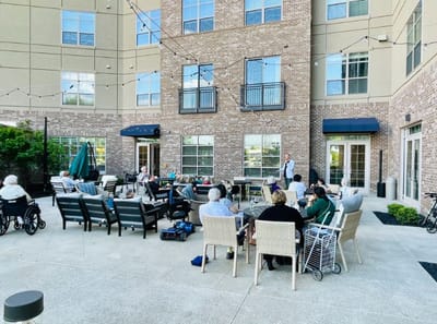 Residents enjoying an outdoor gathering by the building.
