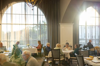 Residents enjoying meals in a bright dining room