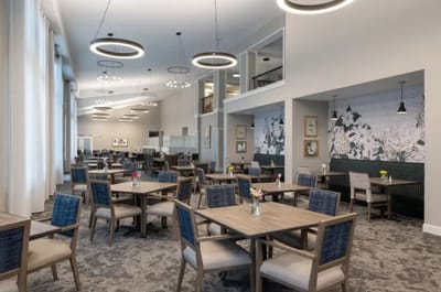 Bright dining area with tables and flowers