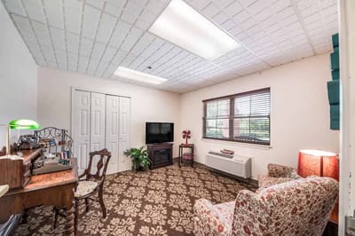 Cozy resident room with furniture and a television