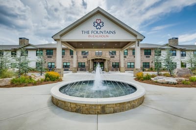 Exterior view of The Fountains in Calhoun with fountain and landscaped entrance