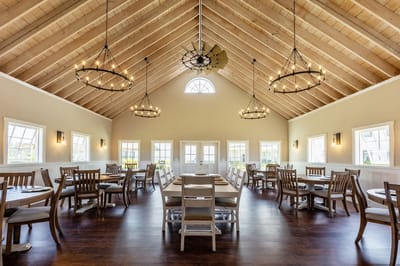 Bright dining area with wooden tables and chandeliers