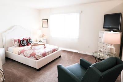 Cozy resident room with a bed and seating area