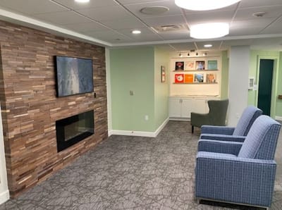 A cozy common area with seating and artwork