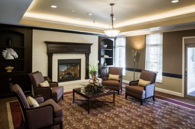 Cozy common area with seating around a fireplace
