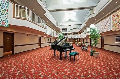 Spacious lobby area with grand piano and seating