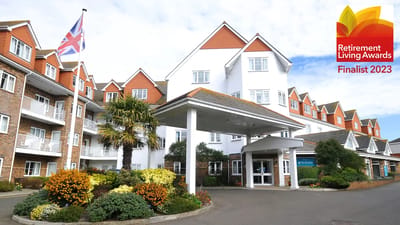Exterior view of The Hawthorns Eastbourne with flowerbeds