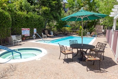 Outdoor pool area with lounge chairs and umbrellas