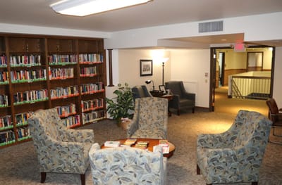 Cozy library area with comfortable seating and bookshelves
