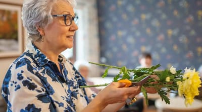Resident arranging flowers during an activity session