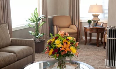 A cozy common area with floral arrangement