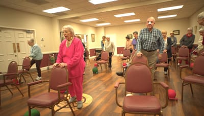Residents participating in a chair exercise class