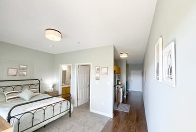Bright resident room with bed and kitchenette