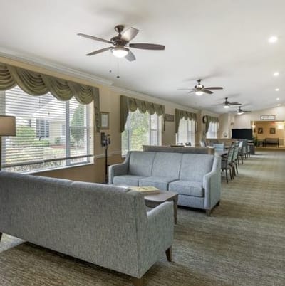 Interior view of a common area with seating and windows