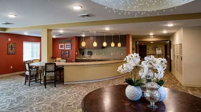 Well-decorated common area with seating and flowers
