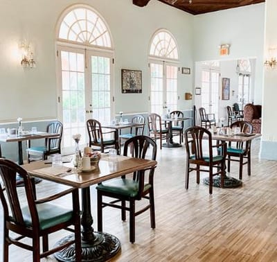 Dining area with tables and chairs arranged for residents