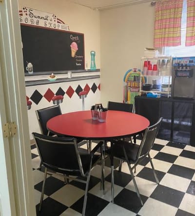 Bright game room with a round table and chairs
