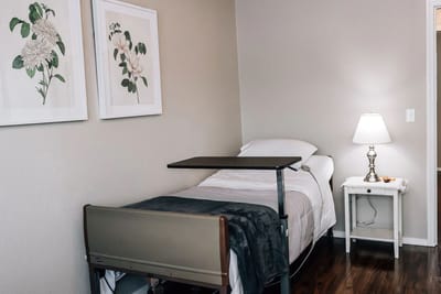 Cozy resident room with floral artwork and a nightstand