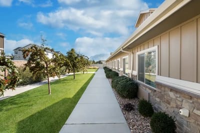 Pathway alongside the facility with green landscaping