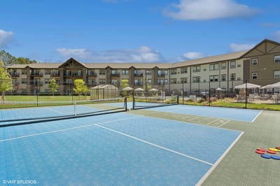 Outdoor tennis courts with the facility in background