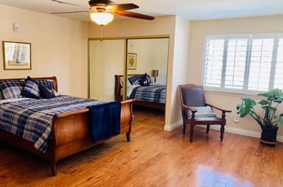 A cozy resident room with a bed and seating area