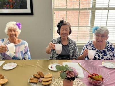 Three women enjoying refreshments at a social gathering