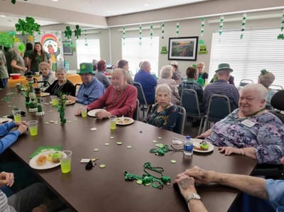 Residents celebrating with decorations and snacks at a table