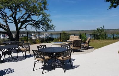 Outdoor patio area with seating and water view